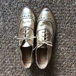 Gold lace up oxfords.
